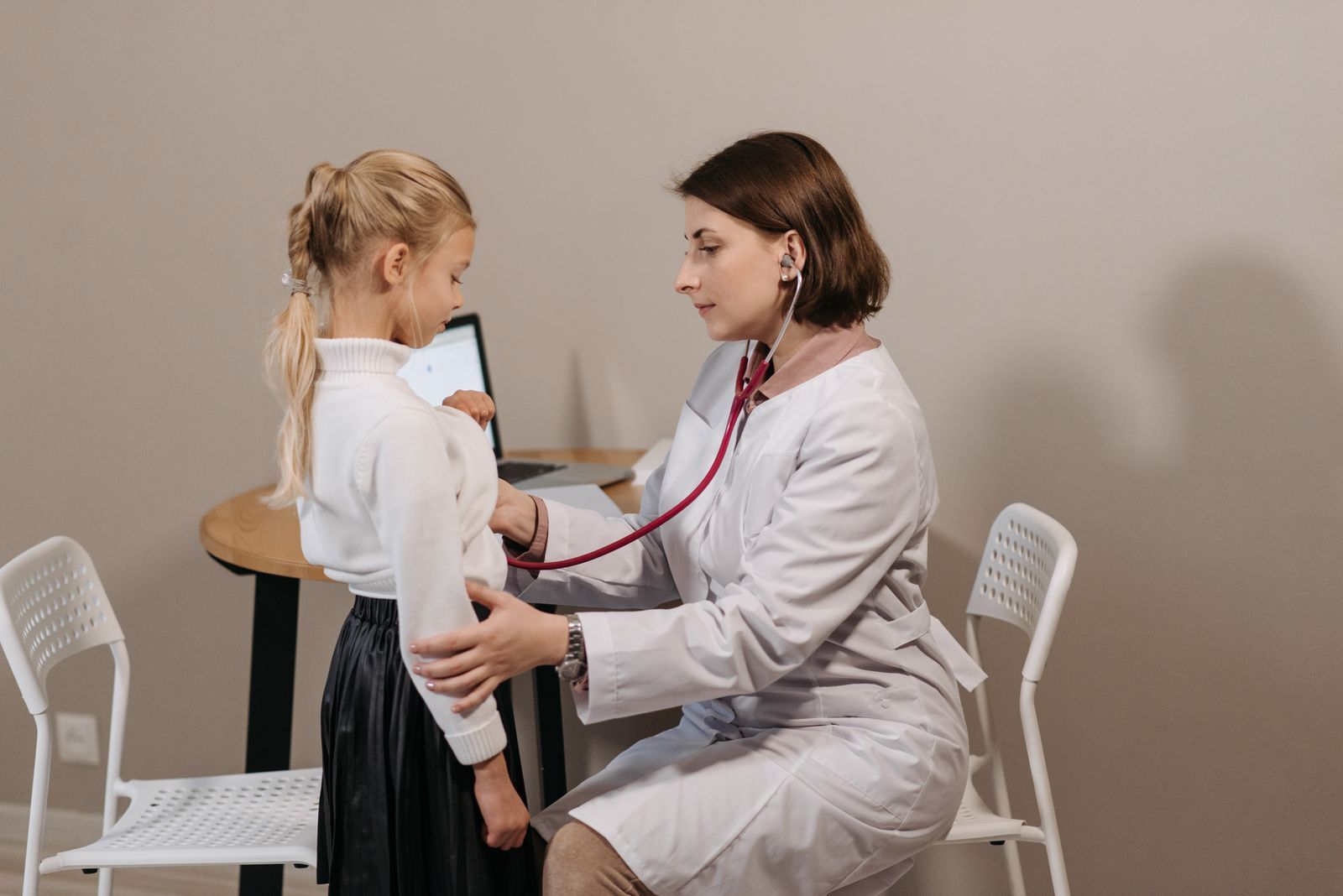 A pediatric nurse checking a young patient’s vital signs during a home visit.